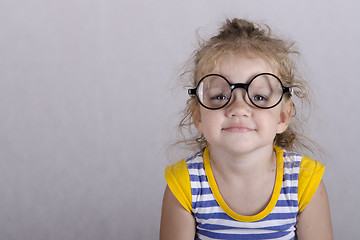 Image showing Two-year-old girl funny glasses sitting looking in frame