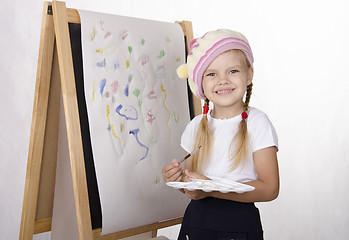 Image showing Girl draws on the easel