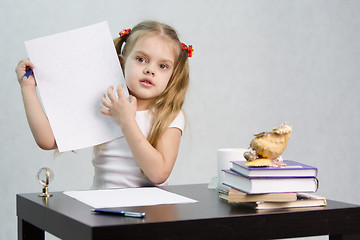 Image showing Girl shows sheet of paper with scribbled notes