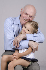 Image showing Portrait of an elderly man embracing a granddaughter