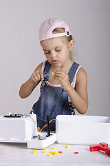 Image showing Girl tighten screws to screw wrench, repairing toy