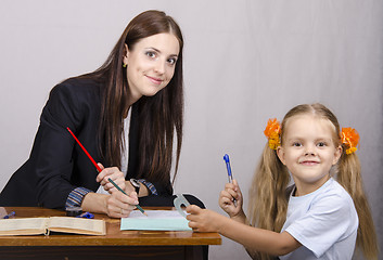 Image showing teacher teaches lessons with student sitting at table