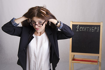Image showing school teacher with a scowl, holding his head