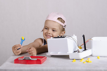 Image showing Girl fun holding a wrench nut, repairing toy