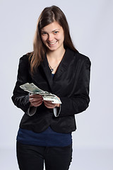 Image showing Young long-haired woman holding money