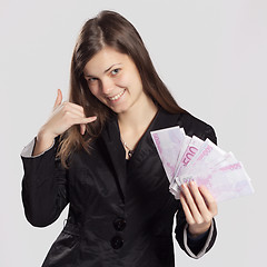 Image showing Young long-haired woman holding money