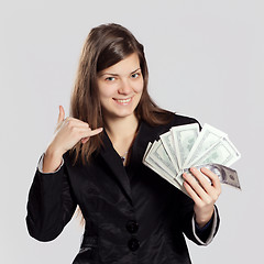 Image showing Young long-haired woman holding money