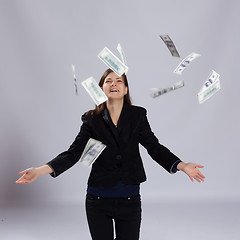 Image showing Young long-haired woman throw money