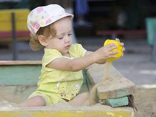 Image showing  Little girl playing in the sandbox