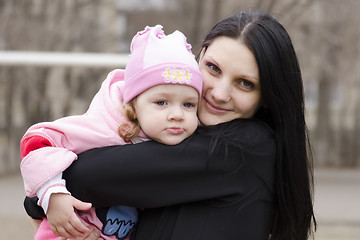 Image showing little girl thoughtfully lies on shoulder of my mother