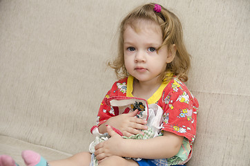 Image showing  little girl was sitting on sofa with scarves in hands of