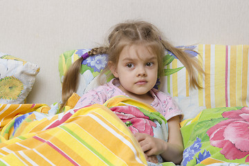 Image showing Four-year-old girl is in bed under the blanket
