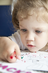 Image showing Girl draws a pencil on sheet of paper