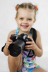 Image showing merry girl keeps SLR camera