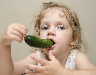 Image showing Girl funny eating cucumber