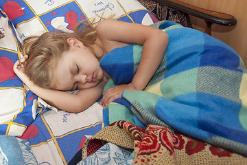 Image showing child of four years sleep in a bed with an old sheets and blankets