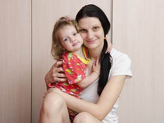 Image showing happy mother, daughter at home cuddling and watching frame