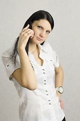 Image showing girl questioning looks in frame talking on phone