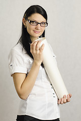 Image showing The girl with a roll of paper