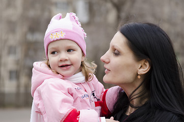 Image showing little girl thoughtfully lies on shoulder of my mother