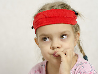 Image showing Girl bites his nails enthusiastically looking left