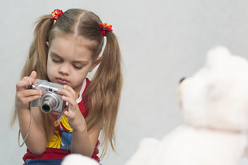 Image showing Girl takes photo of Teddy digital camera