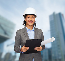 Image showing businesswoman in white helmet with clipboard