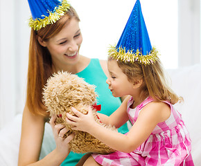 Image showing mother and daughter in blue hats with teddy bear