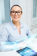 Image showing smiling businesswoman in eyeglasses with tablet pc
