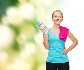 Image showing sporty woman with towel and watel bottle