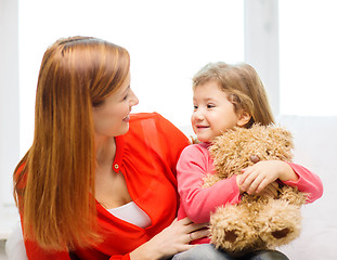 Image showing happy mother and child with teddy bear at home