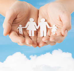 Image showing female hands with paper man family
