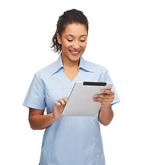 Image showing smiling black doctor or nurse with tablet pc