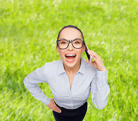 Image showing happy businesswoman in eyeglasses with smartphone