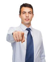 Image showing friendly young buisnessman pointing finger