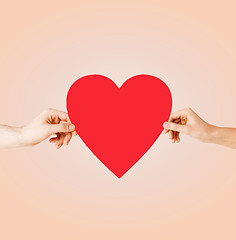 Image showing couple hands holding red heart