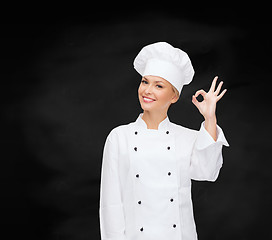 Image showing smiling female chef showing ok hand sign