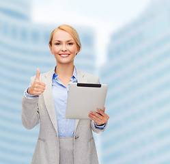 Image showing smiling woman with tablet pc showing thumbs up