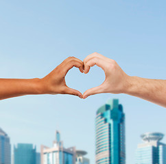 Image showing woman and man hands showing heart shape