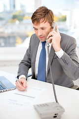 Image showing businessman with laptop computer and phone