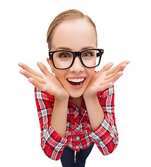 Image showing smiling teenager in eyeglasses screaming