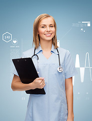 Image showing smiling female doctor or nurse with clipboard