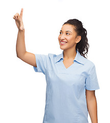 Image showing smiling doctor or nurse pointing to something