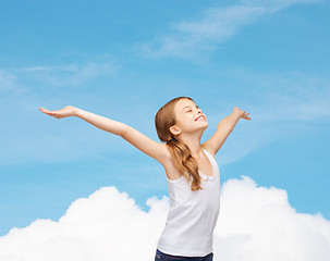 Image showing smiling teenage girl with raised hands