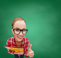 Image showing student in glasses with folders showing thumbs up