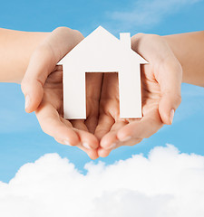 Image showing female hands holding paper house