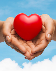 Image showing womans cupped hands showing red heart