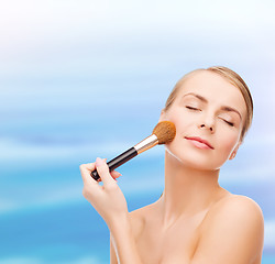 Image showing beautiful woman with makeup brush