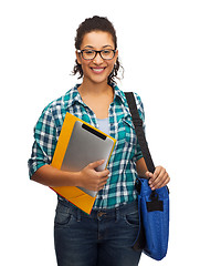 Image showing smiling student with folders, tablet pc and bag