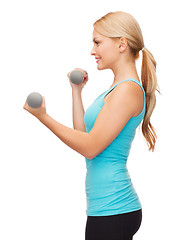 Image showing young sporty woman with light dumbbells